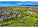 Aerial view showcasing the neighborhood, its green spaces, pool, soccer field, and walking paths at 854 Countrybriar Ln, Highlands Ranch, CO 80129