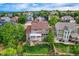 Aerial view of the backyard featuring a well-maintained lawn, patio area, and surrounding mature trees at 854 Countrybriar Ln, Highlands Ranch, CO 80129