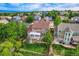 Aerial view of the backyard featuring a well-maintained lawn, patio area, and surrounding mature trees at 854 Countrybriar Ln, Highlands Ranch, CO 80129