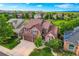 Aerial shot of a lovely two-story home with a well-manicured lawn and beautiful landscaping at 854 Countrybriar Ln, Highlands Ranch, CO 80129