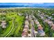 Wide aerial of a neighborhood featuring green spaces, winding roads, and diverse home styles at 854 Countrybriar Ln, Highlands Ranch, CO 80129
