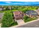 Aerial view showcasing a home with a spacious yard, mature trees, and a wide driveway at 854 Countrybriar Ln, Highlands Ranch, CO 80129