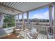 Inviting covered deck with seating, offering a peaceful outdoor space to relax and unwind at 854 Countrybriar Ln, Highlands Ranch, CO 80129