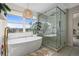 Bright bathroom featuring a freestanding tub, glass shower, and scenic window view at 854 Countrybriar Ln, Highlands Ranch, CO 80129