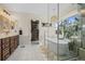 Modern bathroom features a standalone tub, glass shower, and vanity with wooden cabinets at 854 Countrybriar Ln, Highlands Ranch, CO 80129