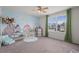Playful bedroom with dinosaur wall mural, a bright window, and furniture at 854 Countrybriar Ln, Highlands Ranch, CO 80129
