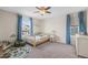 Neutral-colored bedroom with blue drapes, play rug, and a natural wood-colored crib at 854 Countrybriar Ln, Highlands Ranch, CO 80129