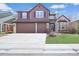 Charming two-story home with a well-manicured lawn and a spacious two-car garage at 854 Countrybriar Ln, Highlands Ranch, CO 80129