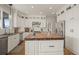 Elegant kitchen featuring white cabinets, a butcher block island, modern stainless steel appliances, and stone flooring at 854 Countrybriar Ln, Highlands Ranch, CO 80129