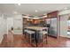 Kitchen with wooden cabinets, stainless steel appliances, and center island with stools at 854 Countrybriar Ln, Highlands Ranch, CO 80129