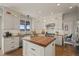 Bright and modern kitchen with white cabinetry, a wooden island, and stainless steel appliances at 854 Countrybriar Ln, Highlands Ranch, CO 80129