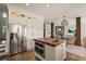 Spacious kitchen featuring stainless steel appliances, a butcher block island, white cabinets, and access to the living area at 854 Countrybriar Ln, Highlands Ranch, CO 80129