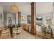 Stylish living space with wood columns, open floor plan, dining area, and elegant decor at 854 Countrybriar Ln, Highlands Ranch, CO 80129
