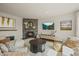 Cozy living room with a stone fireplace, stylish decor, a comfortable couch, and a modern entertainment center at 854 Countrybriar Ln, Highlands Ranch, CO 80129