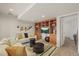 Basement living room with built-in shelving, sofa, and decorative wall hangings at 854 Countrybriar Ln, Highlands Ranch, CO 80129