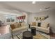 Bright living room with sofas, a decorative wall hanging, and an adjacent office at 854 Countrybriar Ln, Highlands Ranch, CO 80129