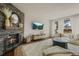 Comfortable living room featuring a stone fireplace, a large television, and a cozy seating area at 854 Countrybriar Ln, Highlands Ranch, CO 80129