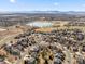 Aerial view of a neighborhood with homes near a lake and golf course in a suburban area at 2730 River View Dr, Broomfield, CO 80023