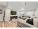 Finished basement boasts a large TV, comfortable sectional, and modern design at 2730 River View Dr, Broomfield, CO 80023