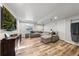 Finished basement features a large sectional sofa, and a modern entertainment center at 2730 River View Dr, Broomfield, CO 80023