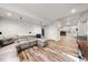 Spacious finished basement features a sectional sofa, modern decor, and ample lighting at 2730 River View Dr, Broomfield, CO 80023