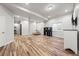 Basement featuring an open floor plan with hardwood floors, a beanbag chair, and built-in shelves at 2730 River View Dr, Broomfield, CO 80023