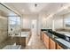 Bright bathroom featuring a glass-enclosed shower, a soaking tub, and a double sink vanity at 2730 River View Dr, Broomfield, CO 80023
