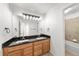 Well-lit bathroom with double sinks, ample counter space, and modern fixtures at 2730 River View Dr, Broomfield, CO 80023
