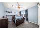 Comfortable bedroom with blue walls, a cozy bed, and a window with outdoor views at 2730 River View Dr, Broomfield, CO 80023