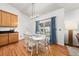 Light-filled dining area with a white table, wood floors and sliding door to the backyard at 2730 River View Dr, Broomfield, CO 80023