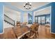 Bright dining room featuring a wood table, chandelier and views into the entry and living room at 2730 River View Dr, Broomfield, CO 80023
