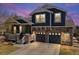 Charming two-story home featuring a stone facade, a covered porch, and a two-car garage at 2730 River View Dr, Broomfield, CO 80023