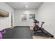 Home gym with exercise equipment, a window, and a motivational artwork at 2730 River View Dr, Broomfield, CO 80023