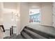 Hallway with carpeted stairs that lead to a bedroom with bright, blue paint and natural light at 2730 River View Dr, Broomfield, CO 80023