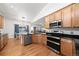 Well-lit kitchen featuring stainless steel appliances and a view into the casual dining area at 2730 River View Dr, Broomfield, CO 80023