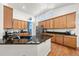 Spacious kitchen with granite countertops, wooden cabinets, and stainless steel appliances at 2730 River View Dr, Broomfield, CO 80023