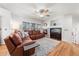 Comfortable living room with a leather sofa, fireplace, and large windows at 2730 River View Dr, Broomfield, CO 80023