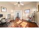 Bright office with french doors, wood floors, dual desks and a ceiling fan at 2730 River View Dr, Broomfield, CO 80023