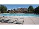 This community pool features lounge chairs, and a great view of the clubhouse with an attached pergola at 2730 River View Dr, Broomfield, CO 80023