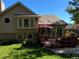 Beautiful backyard featuring a wooden deck with outdoor furniture and lush landscaping at 6833 S Miller St, Littleton, CO 80127