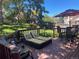 Enjoy lounging on this wooden deck featuring comfortable seating and a dining set with an umbrella at 6833 S Miller St, Littleton, CO 80127