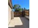 View of backyard concrete pad with a storage shed, privacy fence and mature trees at 6833 S Miller St, Littleton, CO 80127