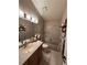 Bathroom featuring a tiled shower-tub combo, updated vanity, and decorative elements at 6833 S Miller St, Littleton, CO 80127