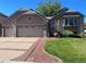 Charming home featuring a well-manicured lawn and a two-car garage at 6833 S Miller St, Littleton, CO 80127