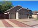 View of the home's exterior showing the two-car garage and manicured landscape at 6833 S Miller St, Littleton, CO 80127