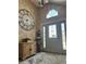 Open foyer features high ceilings, a decorative clock, and a decorative glass front door at 6833 S Miller St, Littleton, CO 80127