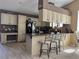 Kitchen with a breakfast bar, black appliances and built-in desk area at 6833 S Miller St, Littleton, CO 80127