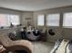 Serene sun room with a chaise lounge, and a table covered with a yin-yang fabric at 6833 S Miller St, Littleton, CO 80127