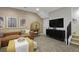 Finished basement featuring a comfortable seating area, stylish decor, and a mounted television for entertainment at 2855 S Pancratia St, Denver, CO 80236