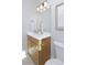 Chic bathroom featuring a wood vanity, quartz countertop, modern fixtures, and a clean, minimalist design at 2855 S Pancratia St, Denver, CO 80236
